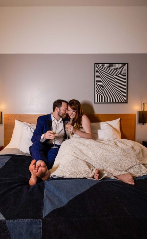 Couple on bed in hotel room