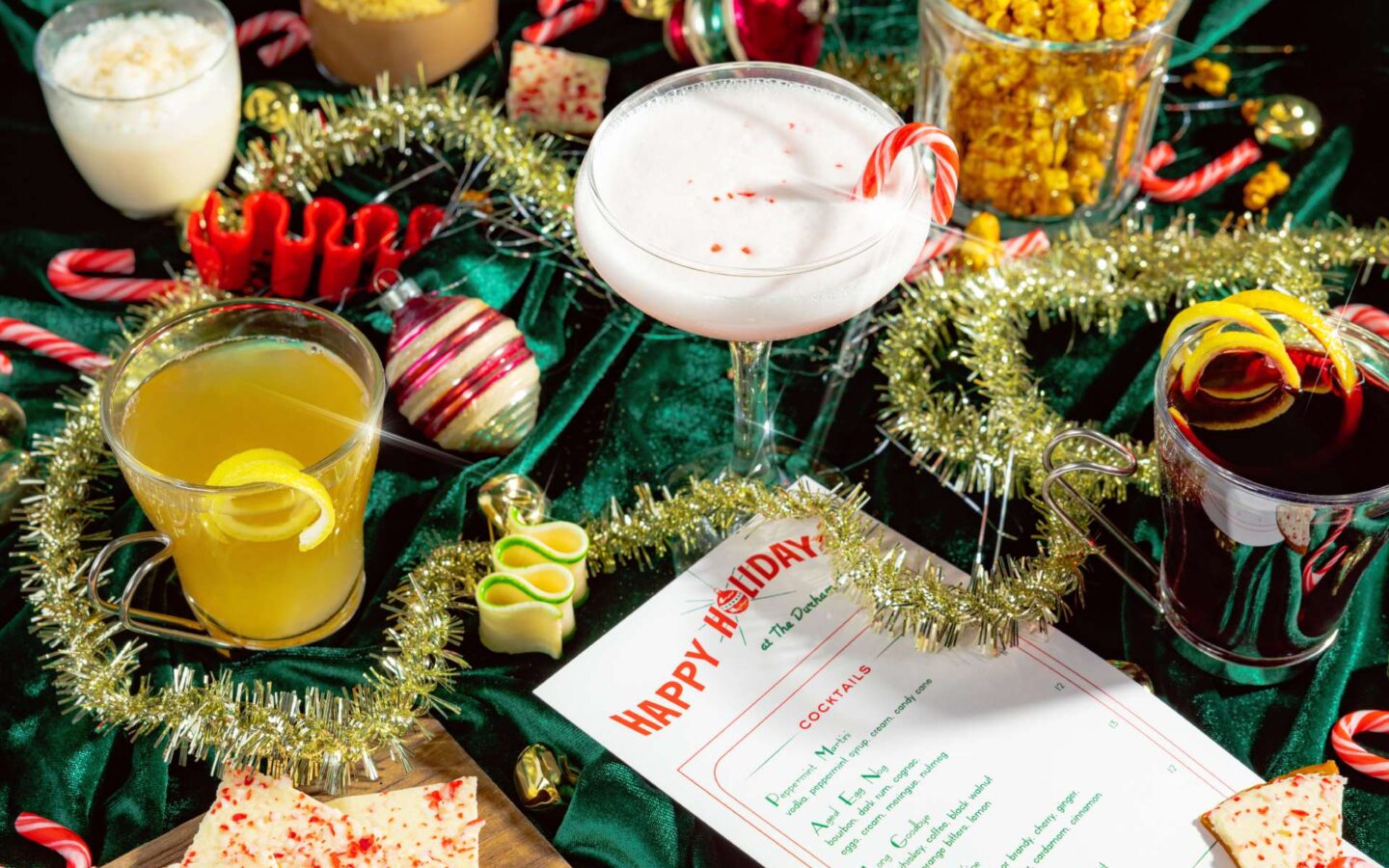 a table topped with drinks, candy canes, and other festive decorations