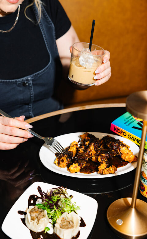 a woman sitting at a table with a plate of food