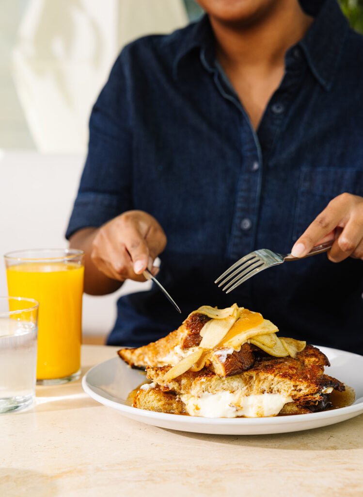 a man sitting at a table with a plate of food