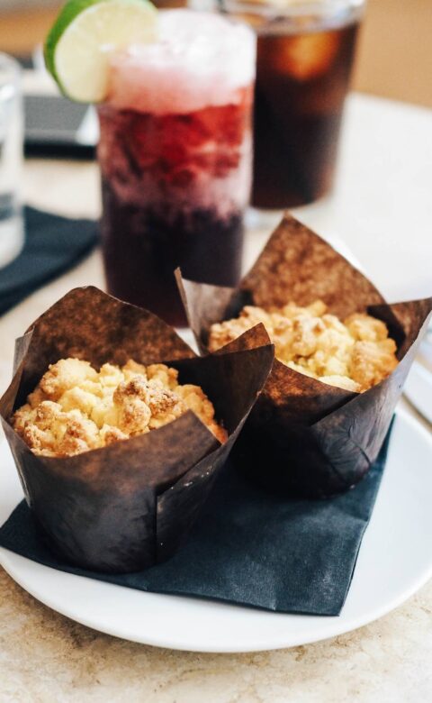 a white plate topped with muffins next to a drink