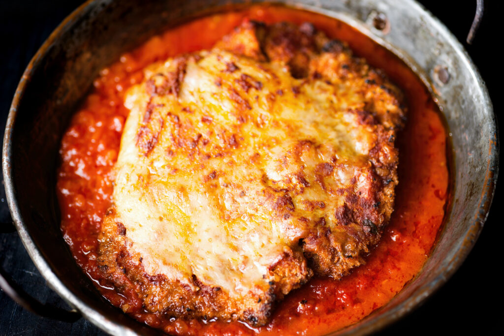 closeup of pan of rustic italian chicken parmesan comfort food